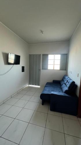a bedroom with a bed and a flat screen tv at Condomínio Jardim Presidente 08 in Cuiabá