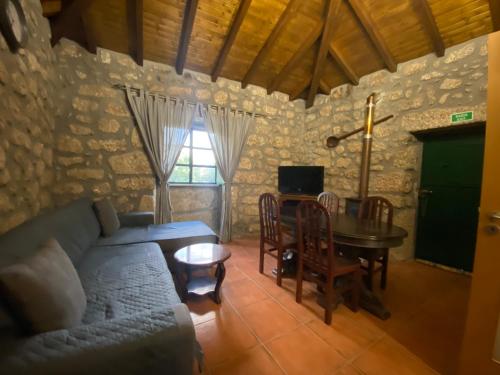 a living room with a couch and a table at Refúgio Rural no Gerês - Casa Araujo de Sousa in Terras de Bouro