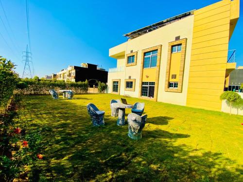 a group of blue chairs in a yard next to a building at Moonlight Guest House in Rawalpindi