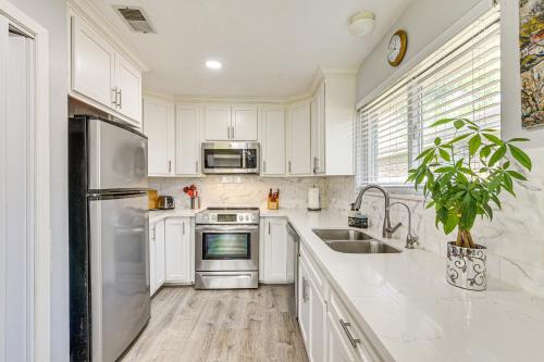 a kitchen with white cabinets and stainless steel appliances at 6 Mi to Clear Lake Family Home with Patio and Yard in Webster