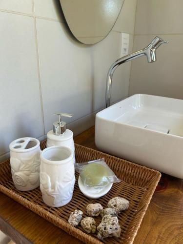 a bathroom with a sink and a tray of food at Casa Brilho do Sol in Zumbi