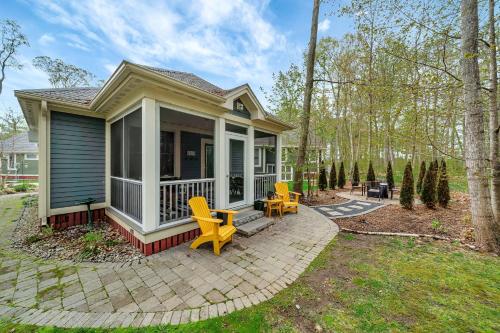 a small house with yellow chairs on a patio at The Elm - 36 Hollow in Cherry Valley