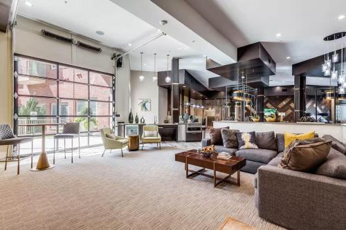 a living room with a couch and a table at 2 BR Heart of Frisco Gem in Frisco