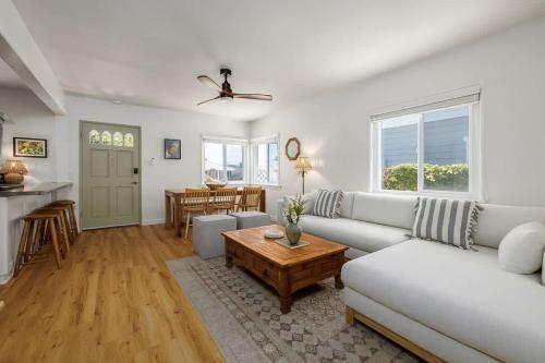 a living room with a white couch and a table at Carlsbad Cottage - Remodeled in Carlsbad