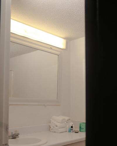 a bathroom with a mirror and a sink at Southern Breeze Ocean Front Hotel in Myrtle Beach