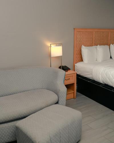 a hotel room with a couch and a bed at Southern Breeze Ocean Front Hotel in Myrtle Beach