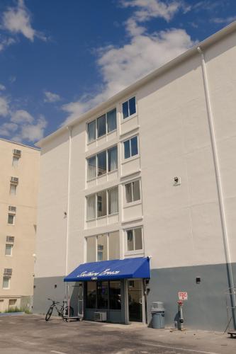 a building with a blue awning in front of it at Southern Breeze Ocean Front Hotel in Myrtle Beach