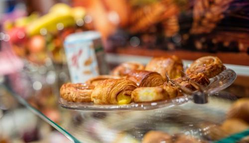 a bunch of pastries on a plate on a counter at Hotel Bellerive in Zermatt