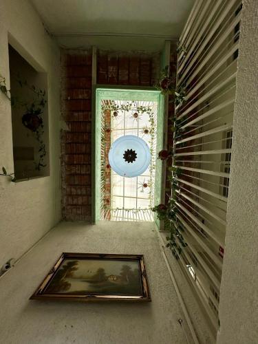 an empty hallway with a door and a window at Hotel Posada Jardín Aguascalientes in Aguascalientes