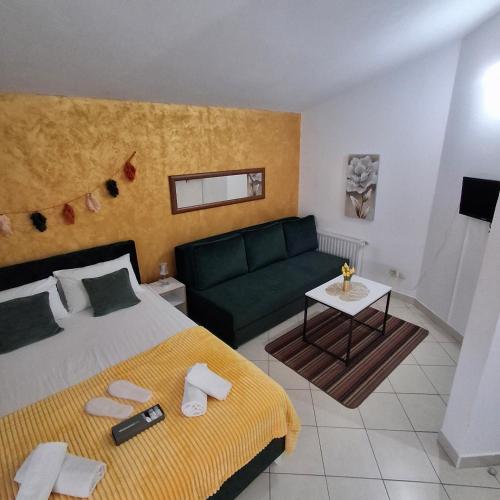 a hotel room with a bed and a couch at Apartmani Villa Anita in Neum