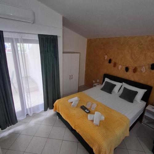 a bedroom with a large bed with towels on it at Apartmani Villa Anita in Neum