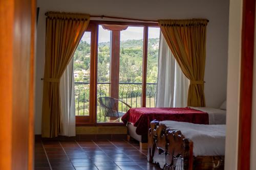Postel nebo postele na pokoji v ubytování Hotel Campestre Cordillera de los Andes