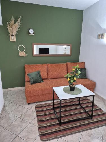 a living room with a couch and a table at Apartmani Villa Anita in Neum