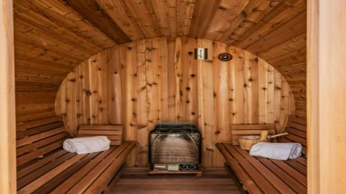 a wooden room with two benches in a sauna at The Dume Legacy in Malibu
