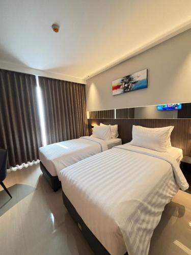 Кровать или кровати в номере Grand Aurel Hotel Morowali