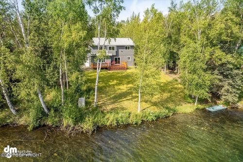 an aerial view of a house next to a river at Serene Four Bedroom Lakefront Home in Wasilla