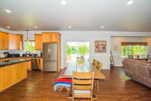 a kitchen with a table and a couch in it at Serene Four Bedroom Lakefront Home in Wasilla