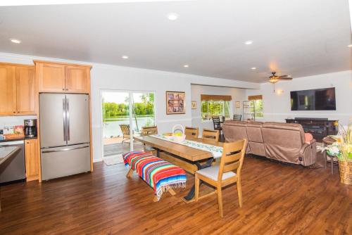 a kitchen and a living room with a table at Serene Four Bedroom Lakefront Home in Wasilla