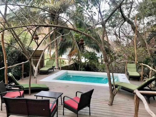 a patio with chairs and a swimming pool at Casa Pauline Beach house habitaciones con acceso directo a playa y alberca in Arroyo Cruz