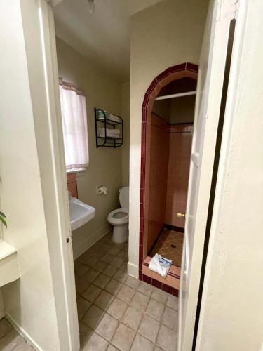 a bathroom with a shower and a toilet and a sink at Sierra Pelona Motel in Santa Clarita