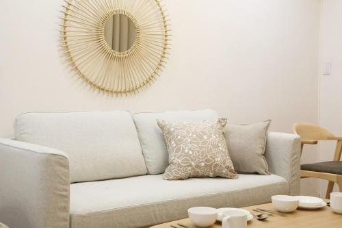 a living room with a couch and a mirror at オグラビル 203 in Tokyo