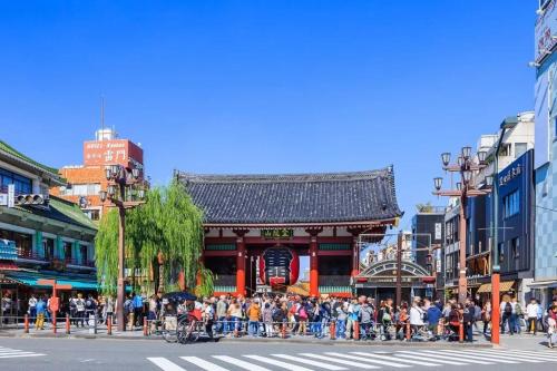 a crowd of people standing in front of a building at オグラビル 203 in Tokyo
