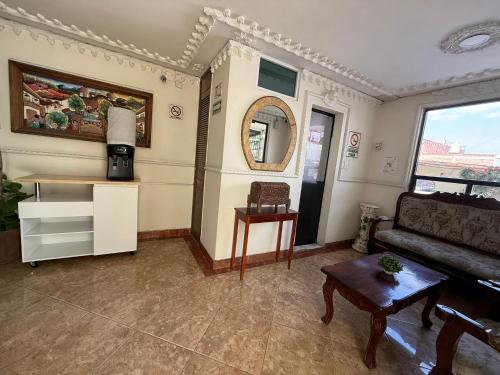 a living room with a couch and a table at Hotel Arbis in Puebla