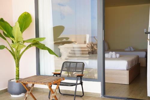 a room with a bed and a table and a chair at Queen Sea Resort - Đảo Phú Quý in Cu Lao Thu