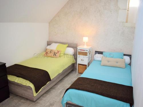 a bedroom with two beds and a night stand at Gîte de charme avec Spa privatif en Touraine - proche châteaux, zoo, et balades pittoresques - FR-1-381-84 in Bridoré