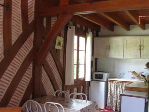 - une cuisine avec une table et une fenêtre dans une chambre dans l'établissement Gîte cosy avec piscine au cœur du Val de Loire, proche châteaux et balades pittoresques - FR-1-381-74, à Limeray