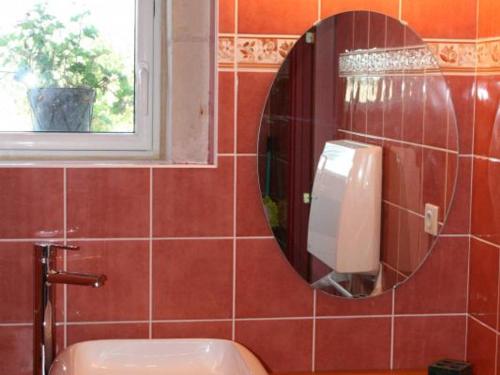 a mirror in a bathroom with a toilet and a window at Gîte de charme avec piscine et sauna en Touraine, proche Châteaux de la Loire et Futuroscope - FR-1-381-323 in Civray-sur-Esves