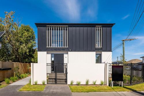 a house with a black and white facade at Lux Local Living in Christchurch