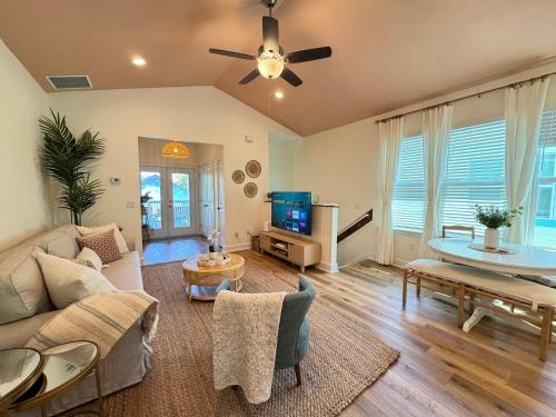 a living room with a couch and a tv at The Orange Blossom Suite Near UF Shands D-town in Gainesville