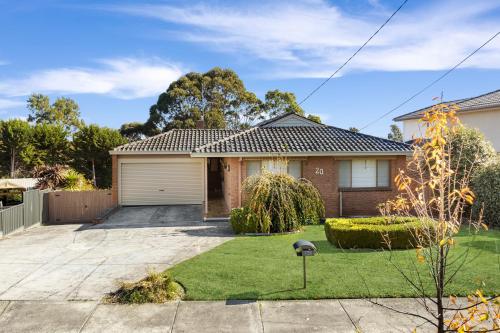 a brick house with a garage in a yard at Spacious 5-Bedroom Home & Pool in Doveton