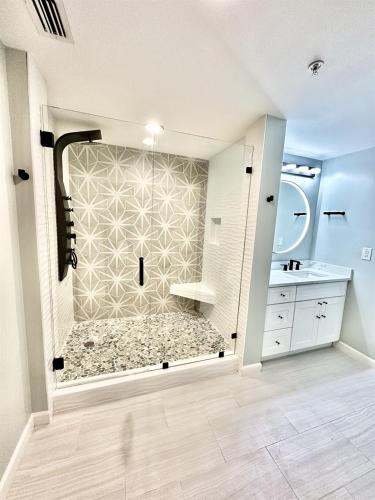 a large bathroom with a shower and a sink at Sterling Reef 907 - Brent's Beach in Panama City Beach
