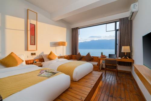Postel nebo postele na pokoji v ubytování Manwu Dali Jimu Boutique Guesthouse