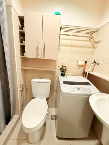 a small bathroom with a toilet and a sink at Shell Residences Condotel by PauL in Manila