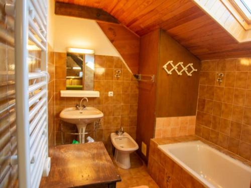 a bathroom with a sink and a tub and a toilet at Maison de campagne spacieuse près de Sarlat avec jardin - FR-1-616-22 in Doissat