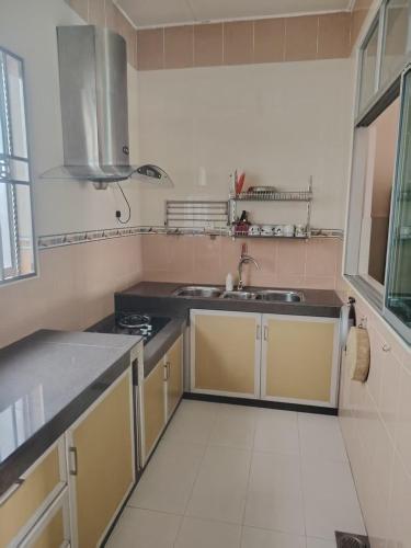 a kitchen with a sink and a counter top at Melor 52 in Bukit Gambir