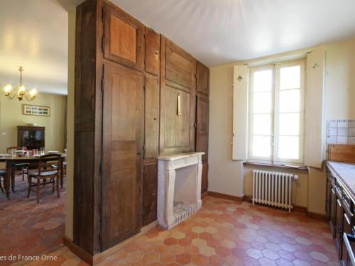 a living room with a fireplace and a dining room at Charmante Maison dans Aile de Château du 18ème avec Jardin et Proximité Étangs, Forêt, Loisirs - FR-1-497-13 in Le Grais
