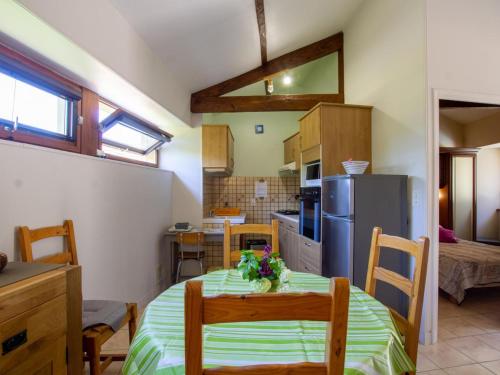 une cuisine et une salle à manger avec une table et un réfrigérateur dans l'établissement Maison avec Terrasse entre Domme et La Roque-Gageac, Idéale Famille, Calme et Verdure - FR-1-616-28, à La Roque-Gageac
