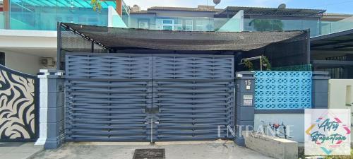 a blue gate in front of a building at Artsy Staycation in Melaka