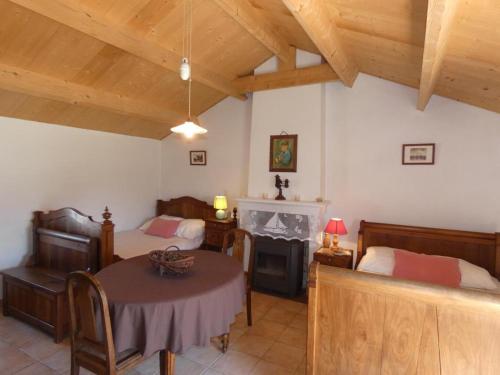 - une chambre avec 2 lits, une table et une cheminée dans l'établissement Maison vendéenne, proche plage, animaux admis, parking - FR-1-540-308, à Notre-Dame-de-Monts