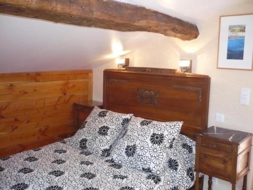 a bedroom with a bed with black and white pillows at Maison cosy avec spa, sauna et lamas à proximité de Roanne - FR-1-496-23 in Saint-André-dʼApchon