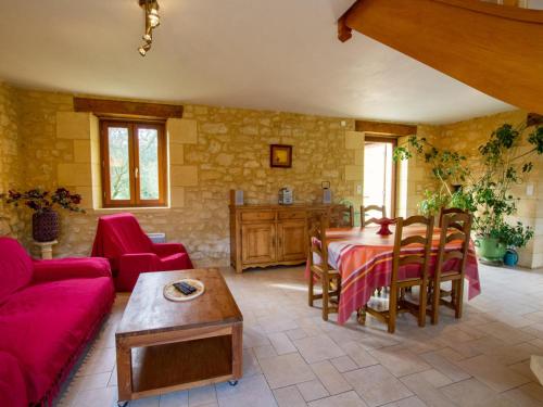 un salon avec un canapé rouge et une table dans l'établissement Maison isolée 6 pers, Dordogne, terrasse, animaux acceptés - FR-1-616-153, à La Roque-Gageac