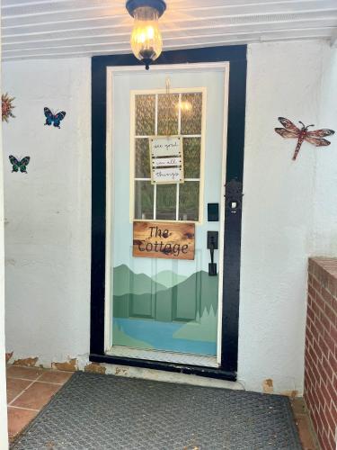 a door with a sign on it with butterflies on it at Grafton Lodge in Lake Lure