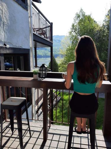 a woman sitting on a chair at a table at Beautiful Condo 3-Eleven at Tremblant in Mont-Tremblant