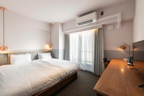 Postel nebo postele na pokoji v ubytování Hotel Asakusa KANNONURA
