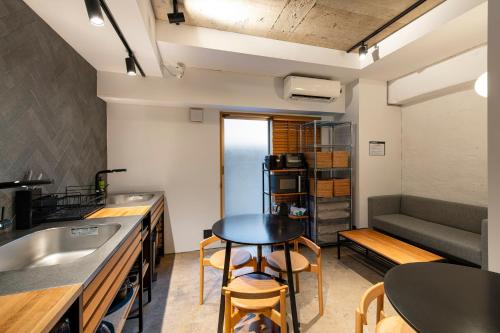a small kitchen with a table and a couch at Hotel Asakusa KANNONURA in Tokyo