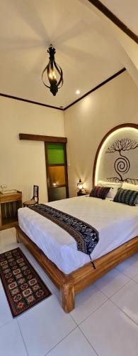 a bedroom with a large bed in a room at Al Mare Karimunjawa in Karimunjawa